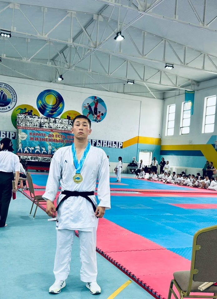 A faculty student on the winner's podium